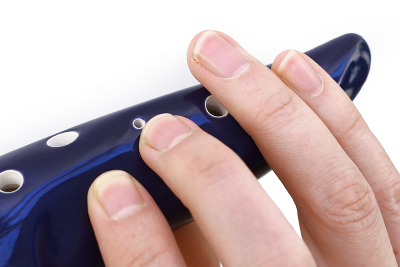 When holding an ocarina it is fine for fingers to overhang past the holes if it allows for a more comfortable hand position. Personally, I overhang my right ring finger about a centimetre or more past the hole