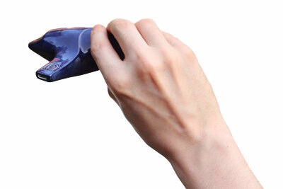 An ocarina held, with the hand angled left. For most people, it is more comfortable to hold an ocarina with the hand angled slightly to the left